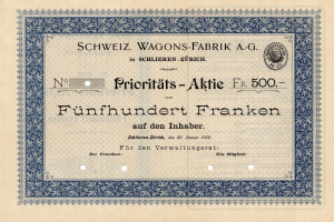 Ein altes deutsches Aktienzertifikat mit blauem Rand, auf dem der Text "Schweiz Wagons-Fabrik A.G." steht